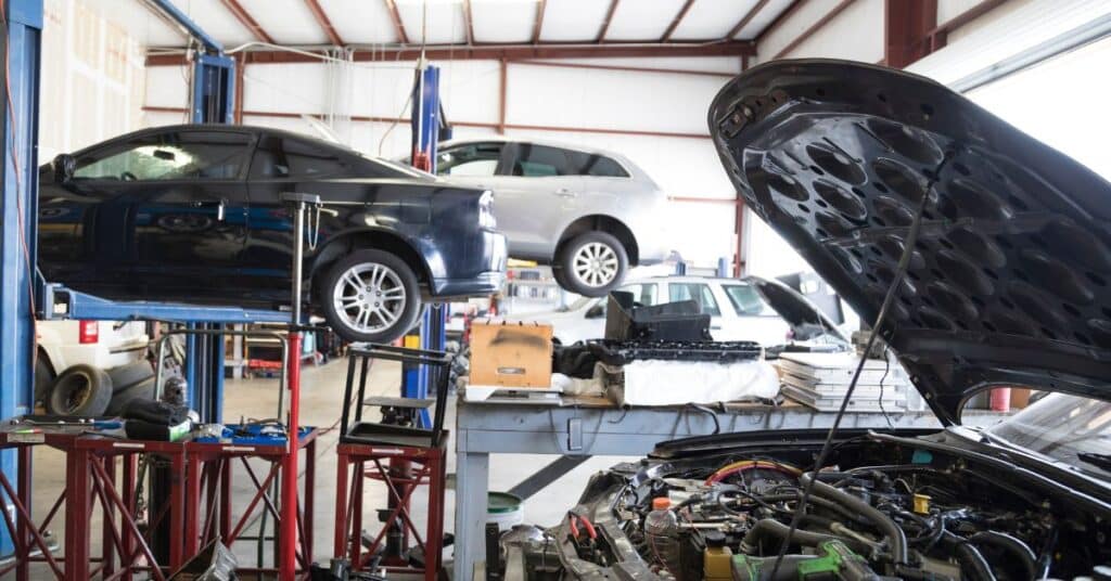 Collision Repair Facility | West Delray Collision - West Delray Collision Center Busy auto body repair facility with multiple vehicles being serviced.
